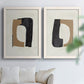 Set of two white barnwood framed canvas prints depicting flat rounded rectangles, irregular openings, and warm paper texture arranged across two complementary compositions above a sofa in a bright living space.