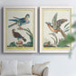 Set of two white barnwood framed canvas prints depicting soft clustered strokes, hazy edges, and spacious white fields arranged across two complementary compositions above a sofa in a bright living space.