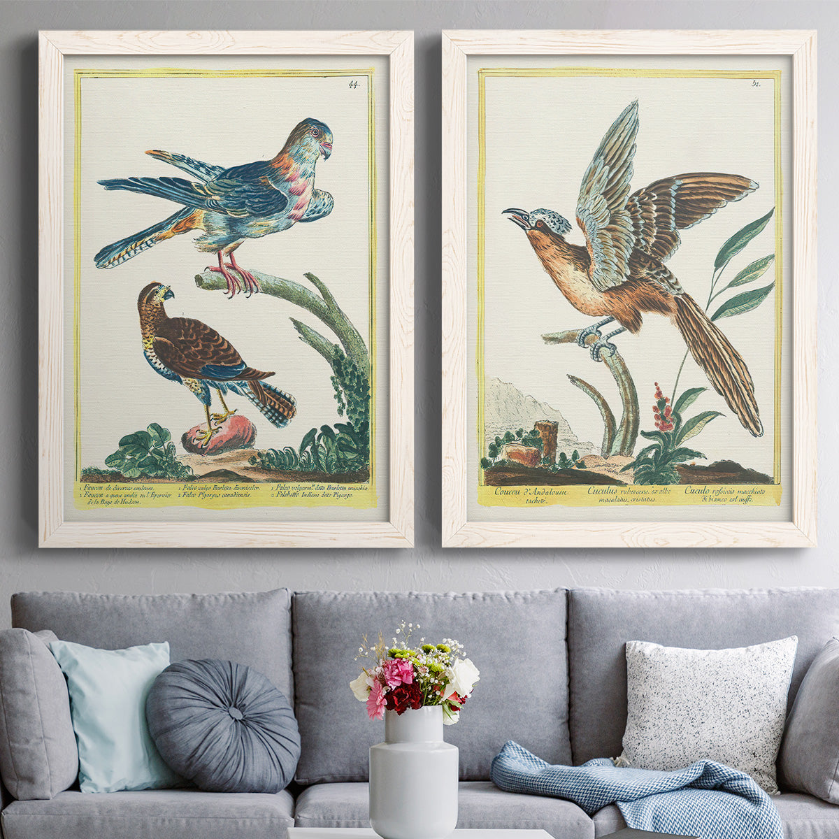 Set of two white barnwood framed canvas prints depicting paired atmospheric abstract paintings with soft clustered strokes, hazy edges, and spacious white fields above a sofa in a contemporary living room.