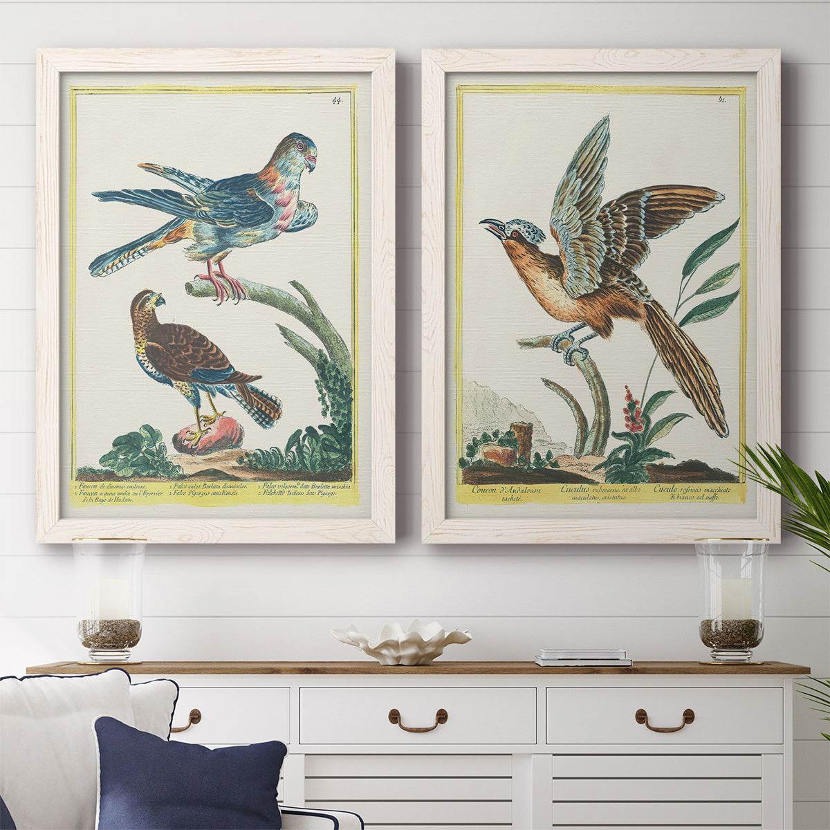 Set of two white barnwood framed canvas prints depicting a coordinated art pair of misty blue gray and violet marks hovering across pale grounds rendered as atmospheric abstract paintings above a dining room sideboard.