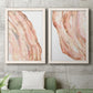 Set of two white barnwood framed canvas prints depicting a coordinated art pair of flowing blush peach and cream mineral bands rendered as soft marble-inspired abstracts above a sofa in a modern living room.