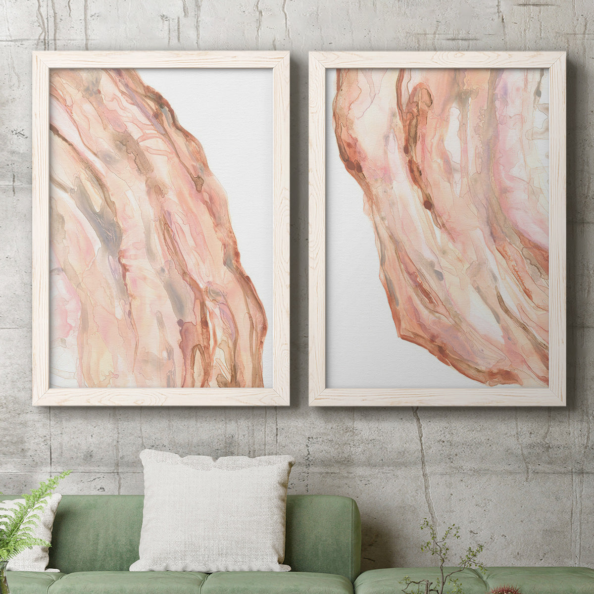 Set of two white barnwood framed canvas prints depicting a coordinated art pair of flowing blush peach and cream mineral bands rendered as soft marble-inspired abstracts above a sofa in a modern living room.