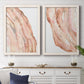 Set of two white barnwood framed canvas prints depicting a coordinated art pair of flowing blush peach and cream mineral bands rendered as soft marble-inspired abstracts above a dining room sideboard.
