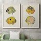 Set of two white barnwood framed canvas prints depicting a coordinated art pair of groups of vintage tropical fish rendered as natural-history fish illustrations above a sofa in a modern living room.
