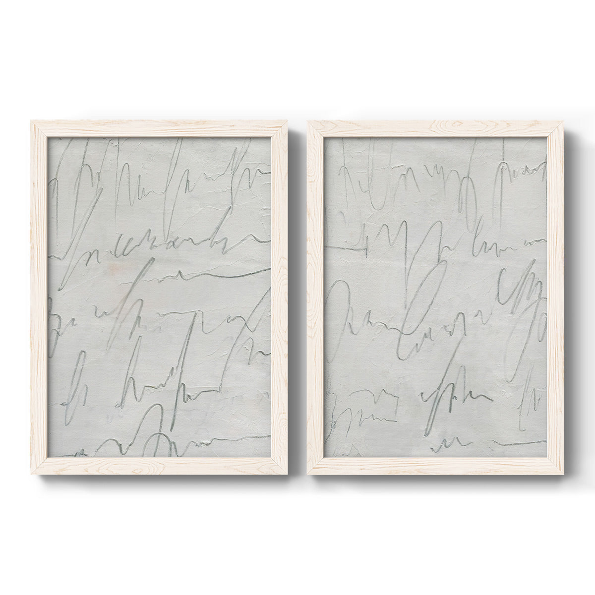Set of two white barnwood framed canvas prints featuring two minimalist script abstracts featuring faint looping handwriting across pale gray grounds.