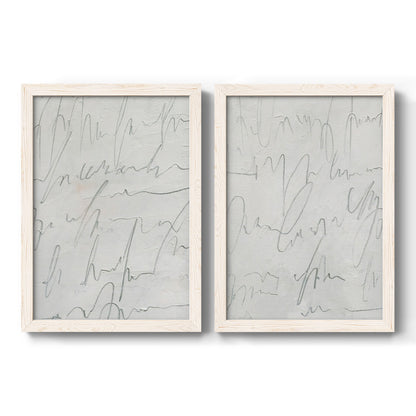 Set of two white barnwood framed canvas prints featuring two minimalist script abstracts featuring faint looping handwriting across pale gray grounds.