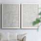 Set of two white barnwood framed canvas prints depicting thin graphite-like lines, subtle texture, and quiet monochrome fields arranged across two complementary compositions above a sofa in a bright living space.