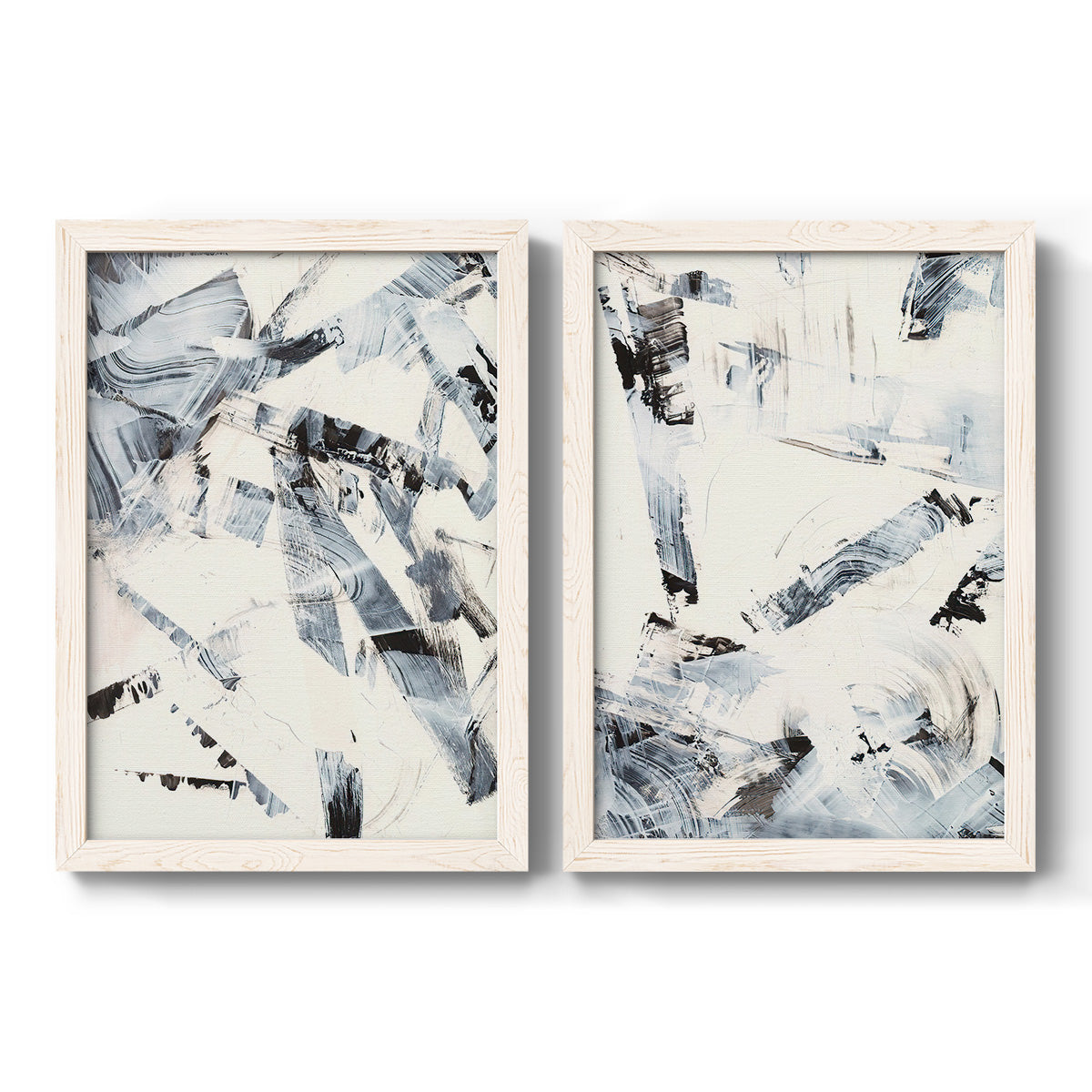 Set of two white barnwood framed canvas prints featuring two high-contrast gestural abstracts featuring angular black and gray brush fragments on white.