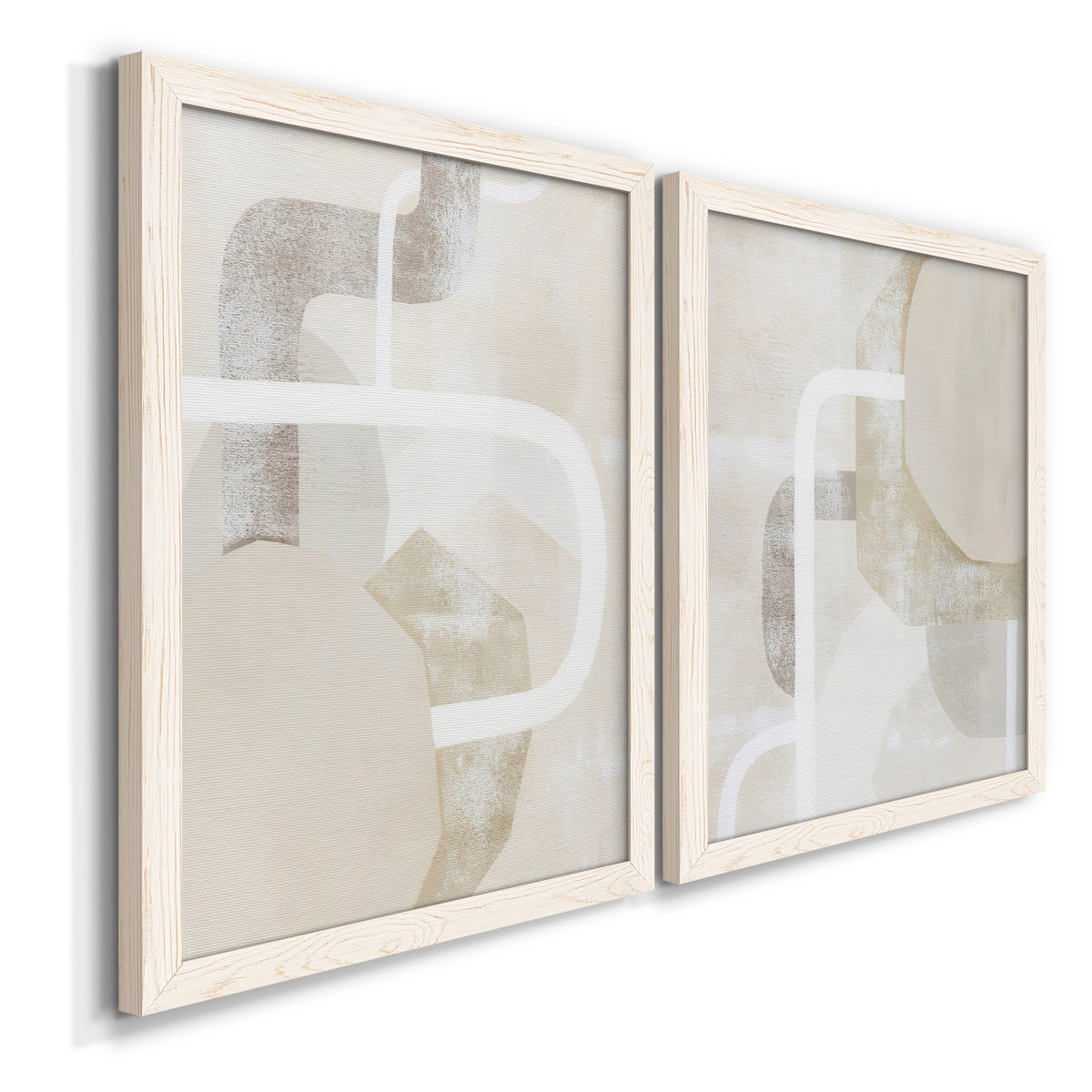 Angled view of a set of two white barnwood framed canvas prints featuring two neutral geometric abstracts with overlapping rounded forms white lines and soft beige gray textures.