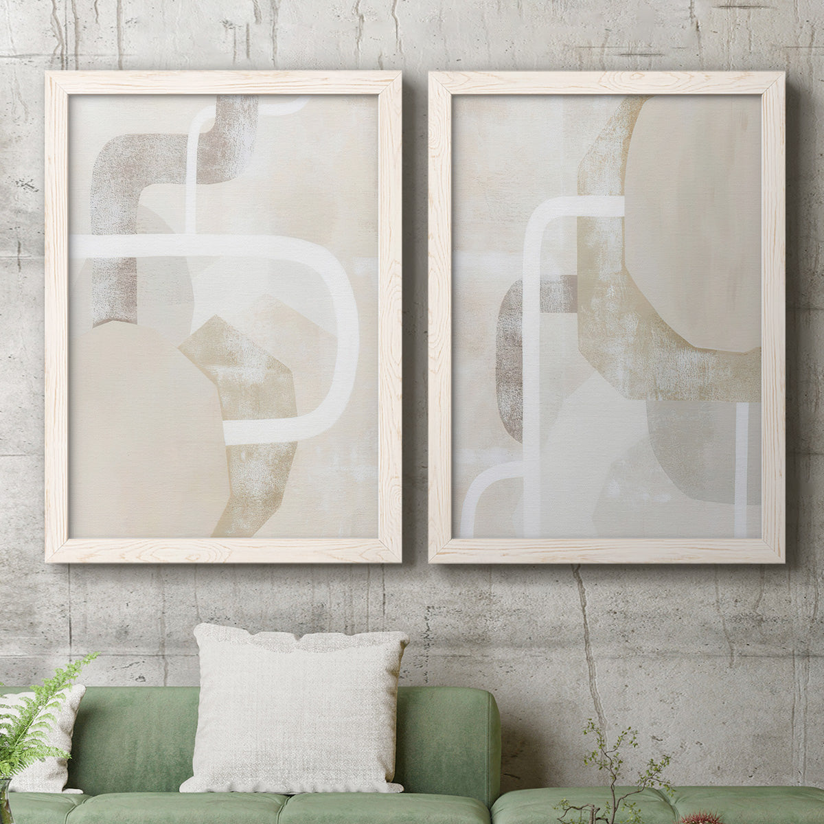 Set of two white barnwood framed canvas prints depicting a minimalist abstract pair of layered curves blocks and sweeping white linear shapes above a sofa in a modern living room.