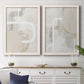 Set of two white barnwood framed canvas prints depicting a minimalist abstract pair of layered curves blocks and sweeping white linear shapes above a dining room sideboard.