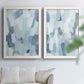 Set of two white barnwood framed canvas prints depicting overlapping rectangular marks and softly weathered paint arranged across two complementary compositions above a sofa in a bright living space.