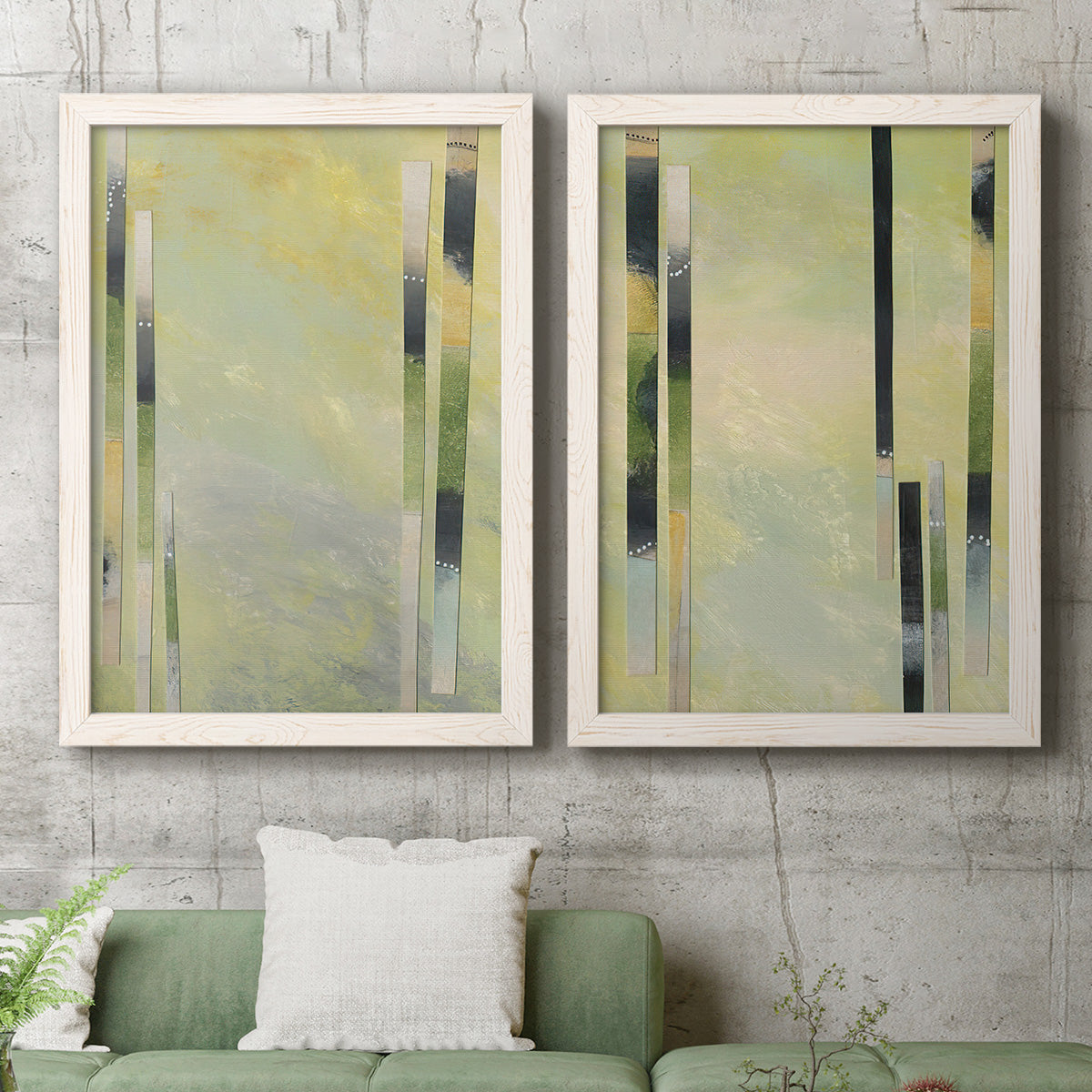 Set of two white barnwood framed canvas prints depicting a coordinated art pair of vertical black gray and olive bars rendered as minimalist architectural abstracts above a sofa in a modern living room.