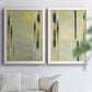 Set of two white barnwood framed canvas prints depicting slender rectangular elements, pale yellow fields, and subtle layered texture arranged across two complementary compositions above a sofa in a bright living space.