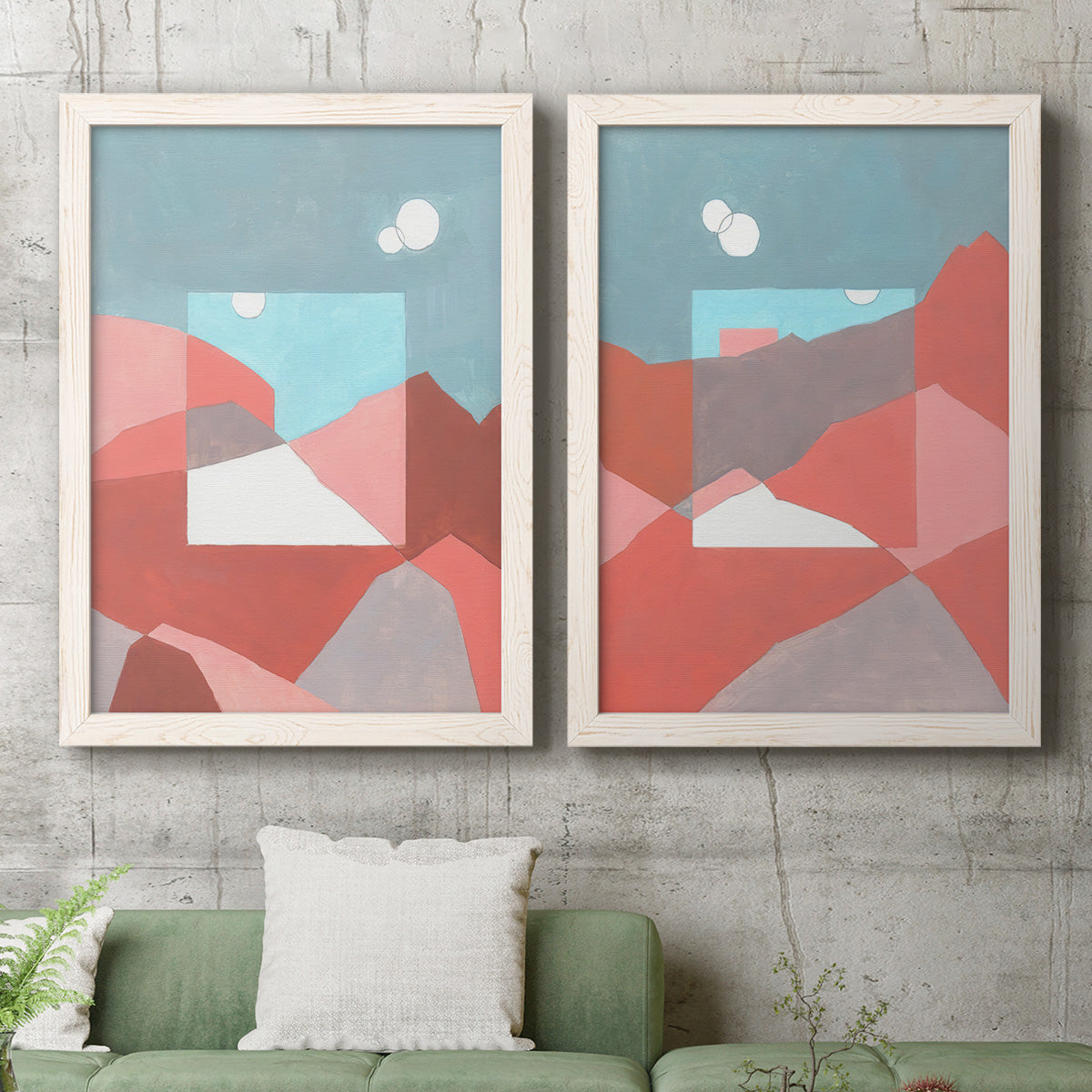 Set of two white barnwood framed canvas prints depicting a coordinated art pair of layered red coral and turquoise desert-like geometry rendered as modern abstract landscapes above a sofa in a modern living room.