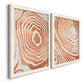Angled view of a set of two white barnwood framed canvas prints featuring two minimalist marbled pattern abstracts featuring concentric wood-grain rings and rippling contour lines.