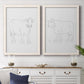 Set of two white barnwood framed canvas prints depicting a coordinated art pair of simple contour drawings of standing cows rendered as minimalist livestock sketches above a dining room sideboard.