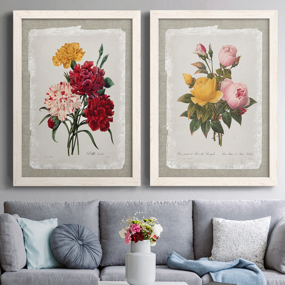 Set of two white barnwood framed canvas prints depicting paired traditional botanical collage prints with roses anemones carnations leaves and archival script details above a sofa in a contemporary living room.