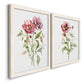 Angled view of a set of two white barnwood framed canvas prints featuring two traditional watercolor flower studies featuring two airy wildflower stems with pink and burgundy blossoms.