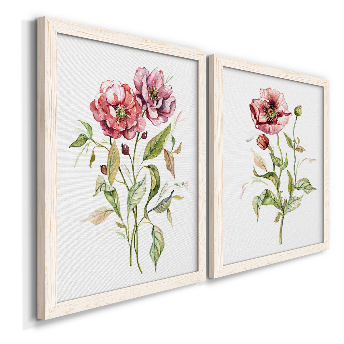 Angled view of a set of two white barnwood framed canvas prints featuring two traditional watercolor flower studies featuring two airy wildflower stems with pink and burgundy blossoms.