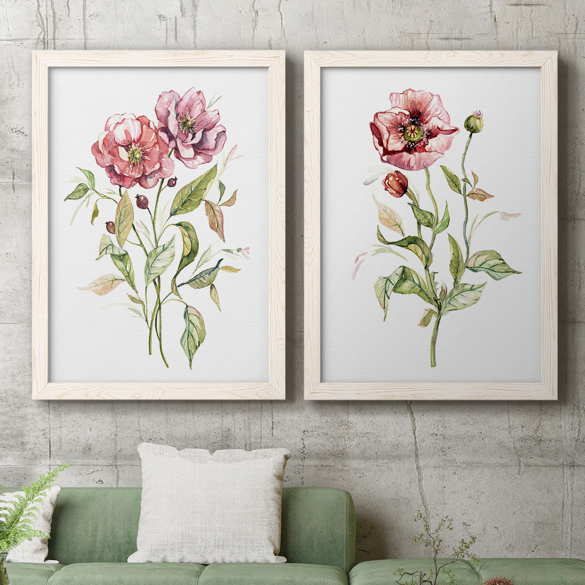 Set of two white barnwood framed canvas prints depicting a coordinated art pair of two airy wildflower stems with pink and burgundy blossoms rendered as traditional watercolor flower studies above a sofa in a modern living room.