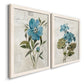 Angled view of a set of two white barnwood framed canvas prints featuring two rustic floral illustrations featuring blue peony and hydrangea-like blooms over vintage script.