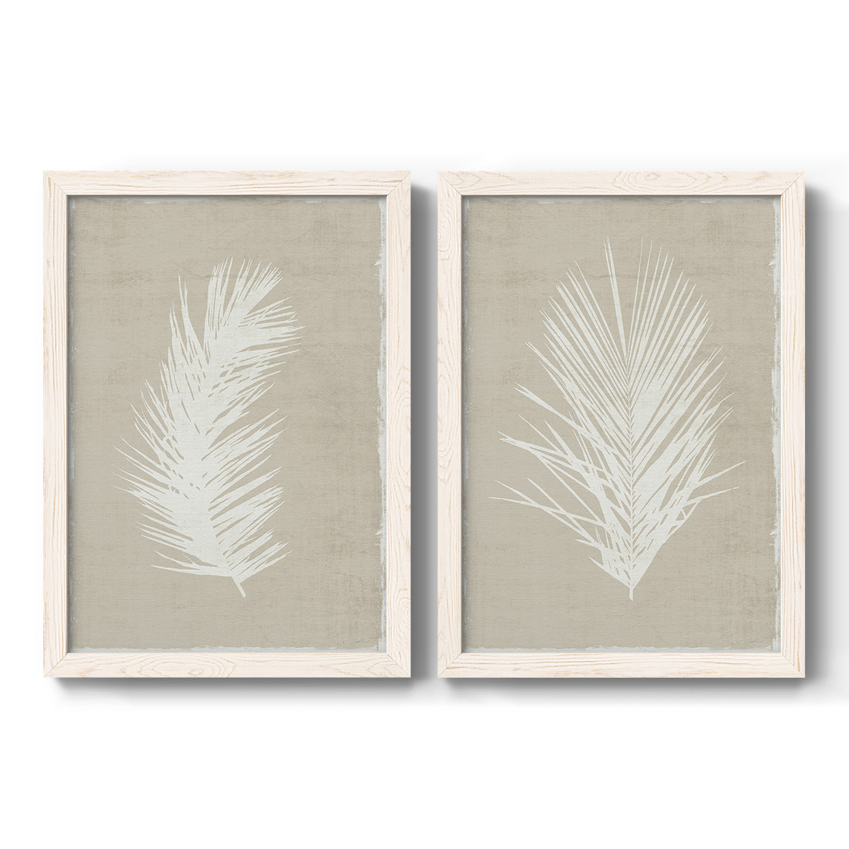 Set of two white barnwood framed canvas prints featuring two minimalist tropical botanical prints featuring white palm frond silhouettes.
