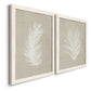 Angled view of a set of two white barnwood framed canvas prints featuring two minimalist tropical botanical prints featuring white palm frond silhouettes.