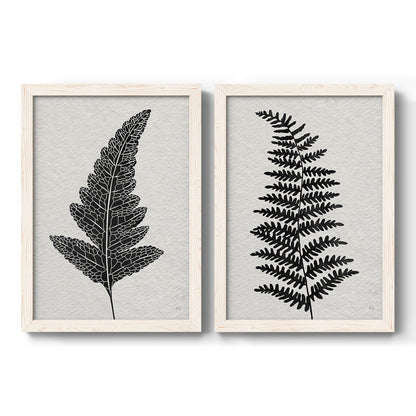 Set of two white barnwood framed canvas prints featuring two minimalist botanical prints featuring black fern leaf silhouettes.