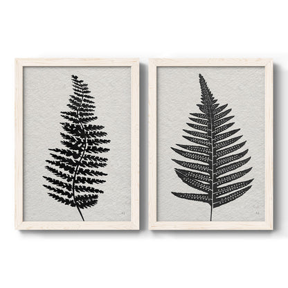 Set of two white barnwood framed canvas prints featuring two minimalist botanical prints featuring black fern leaf silhouettes.