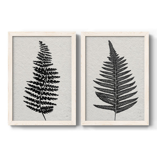 Set of two white barnwood framed canvas prints featuring two minimalist botanical prints featuring black fern leaf silhouettes.