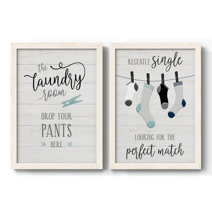 Set of two white barnwood framed canvas prints featuring two rustic typographic wall art featuring humorous laundry-room sayings and clothing icons.