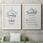Set of two white barnwood framed canvas prints depicting a coordinated art pair of humorous laundry-room sayings and clothing icons rendered as rustic typographic wall art above a sofa in a modern living room.