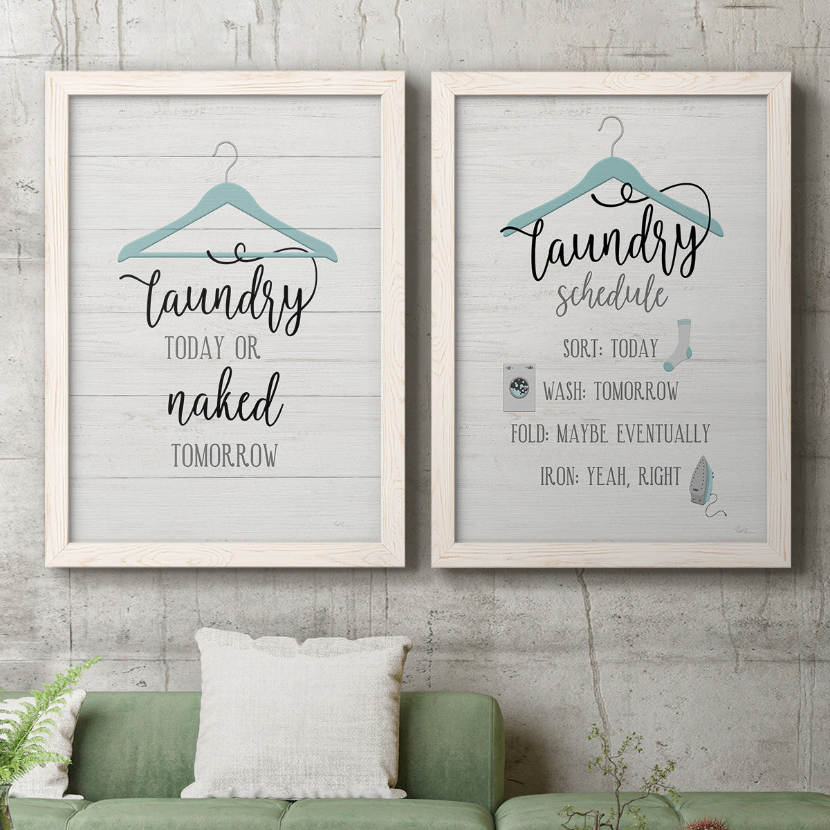 Set of two white barnwood framed canvas prints depicting a coordinated art pair of humorous laundry-room sayings and clothing icons rendered as rustic typographic wall art above a sofa in a modern living room.