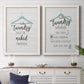 Set of two white barnwood framed canvas prints depicting a coordinated art pair of humorous laundry-room sayings and clothing icons rendered as rustic typographic wall art above a dining room sideboard.