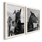 Angled view of a set of two white barnwood framed canvas prints featuring two modern equestrian photography featuring black-and-white close-up portraits of horses at fences.