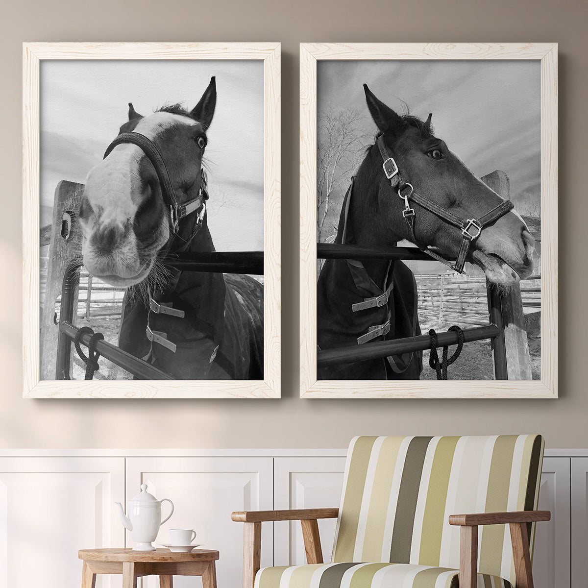 Set of two white barnwood framed canvas prints depicting two modern equestrian photography featuring black-and-white close-up portraits of horses at fences above a sideboard in a cozy sitting room.