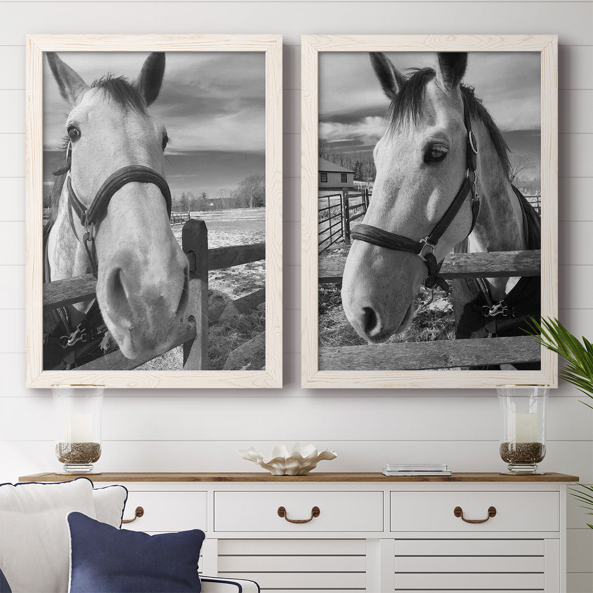 Set of two white barnwood framed canvas prints depicting a coordinated art pair of black-and-white close-up portraits of horses at fences rendered as modern equestrian photography above a dining room sideboard.