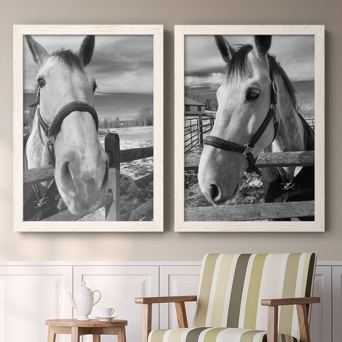 Set of two white barnwood framed canvas prints depicting two modern equestrian photography featuring black-and-white close-up portraits of horses at fences above a sideboard in a cozy sitting room.
