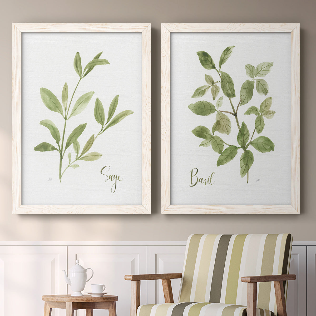 Set of two white barnwood framed canvas prints depicting two farmhouse herb illustrations featuring culinary sage and basil sprigs with handwritten labels above a sideboard in a cozy sitting room.