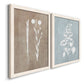 Angled view of a set of two white barnwood framed canvas prints featuring two rustic minimalist botanical prints featuring white botanical silhouettes on softly weathered neutral backgrounds.