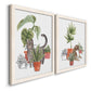 Angled view of a set of two white barnwood framed canvas prints featuring two whimsical botanical animal illustrations featuring cats tucked among collections of potted houseplants.