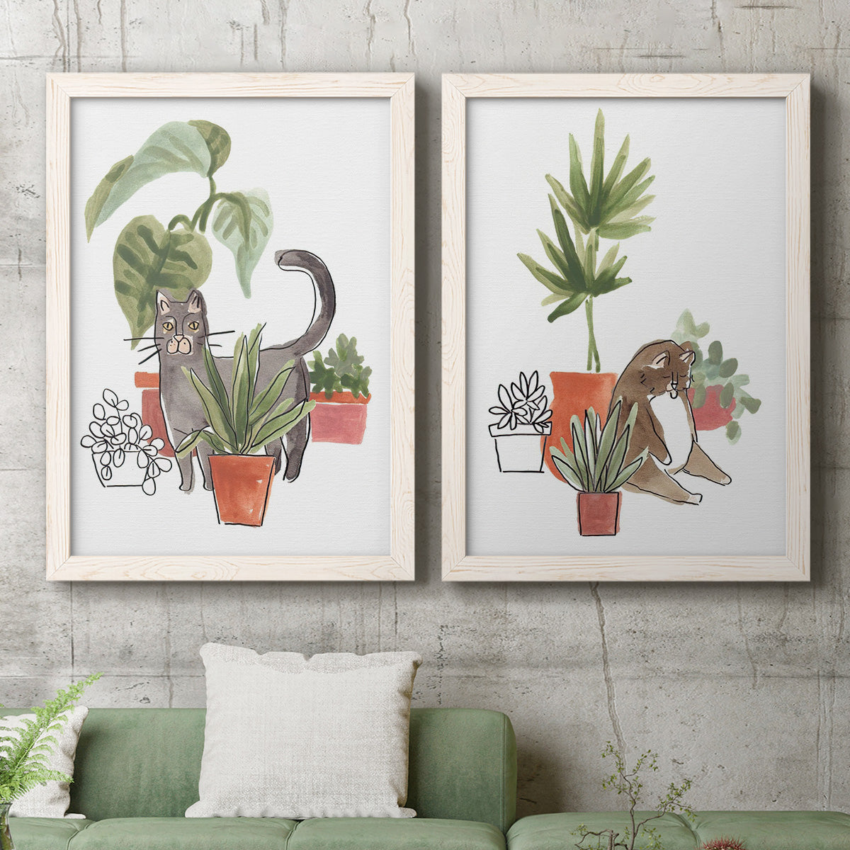 Set of two white barnwood framed canvas prints depicting a coordinated art pair of cats tucked among collections of potted houseplants rendered as whimsical botanical animal illustrations above a sofa in a modern living room.