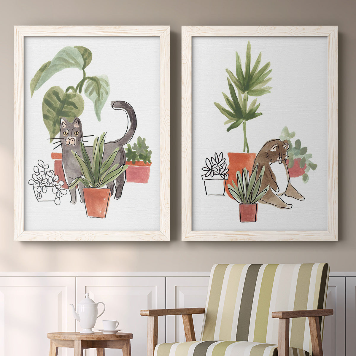 Set of two white barnwood framed canvas prints depicting two whimsical botanical animal illustrations featuring cats tucked among collections of potted houseplants above a sideboard in a cozy sitting room.