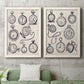 Set of two white barnwood framed canvas prints depicting a coordinated art pair of collections of antique pocket watches and chains rendered as vintage object sketches above a sofa in a modern living room.