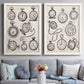 Set of two white barnwood framed canvas prints depicting paired vintage object sketches with black engraved timepieces, winding stems, and cream archival paper above a sofa in a contemporary living room.