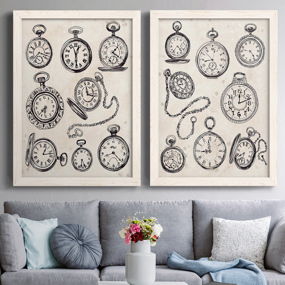Set of two white barnwood framed canvas prints depicting paired vintage object sketches with black engraved timepieces, winding stems, and cream archival paper above a sofa in a contemporary living room.