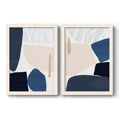 Set of two white barnwood framed canvas prints featuring two minimalist color-block abstracts featuring large navy cream and beige organic geometric shapes.
