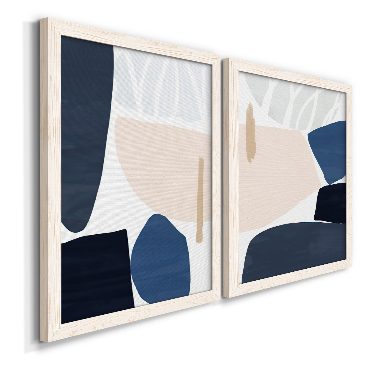 Angled view of a set of two white barnwood framed canvas prints featuring two minimalist color-block abstracts featuring large navy cream and beige organic geometric shapes.