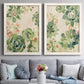 Set of two white barnwood framed canvas prints depicting paired decorative botanical pattern prints with green rosettes, peach blossoms, and mosaic-like outlines above a sofa in a contemporary living room.